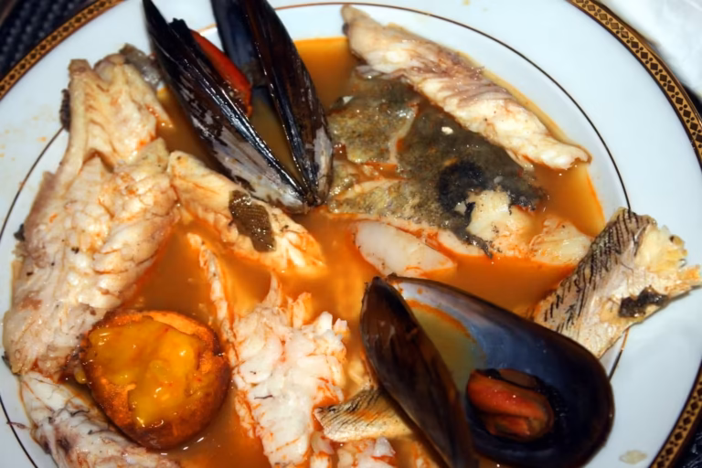 Assiette de bouillabaisse sétoise avec filets de poisson, moules et croûton à l'aïoli