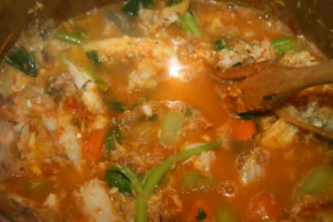 Soupe de poissons en cours de mijotage avec céleri, carottes et chair de poisson